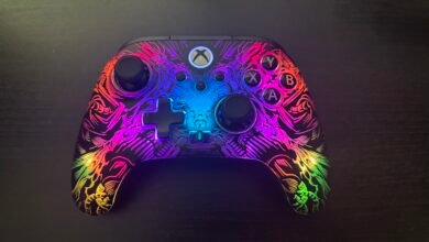 Close-up of a custom Xbox controller with a vibrant, glowing dragon design.