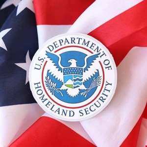 Seal of the U.S. Department of Homeland Security superimposed on the American flag.