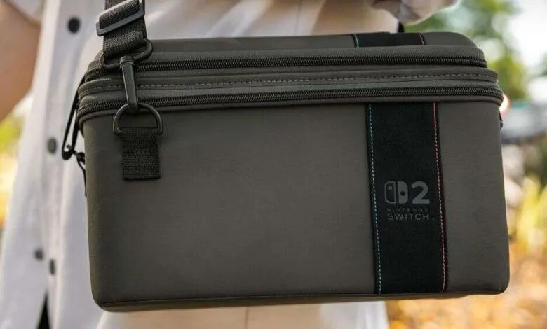 Close-up of a dark grey Nintendo Switch carrying case with a black strap.