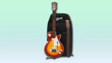 A red and orange Gibson Les Paul style guitar controller with a black Gibson bag and a separate guitar neck.