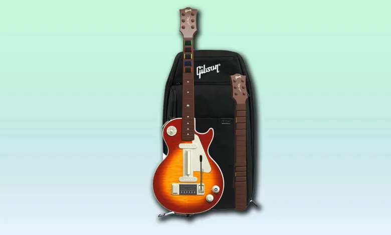 A red and orange Gibson Les Paul style guitar controller with a black Gibson bag and a separate guitar neck.