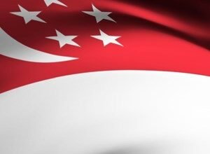 Close-up of the Singapore flag waving, showing red, white, and five white stars.