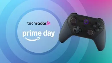 A dark gray game controller with purple accents, displayed against a gradient background with TechRadar and Prime Day logos.