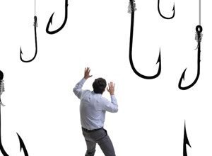 Man in a suit looking up at large fishing hooks against a white background.