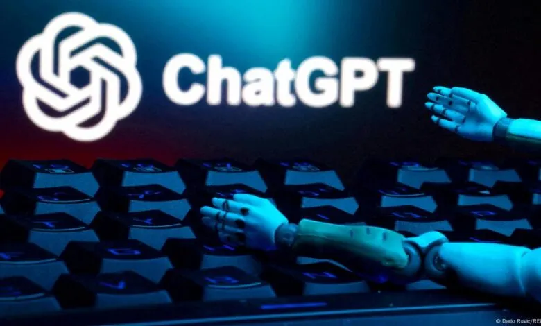 Robotic hands reaching towards the ChatGPT logo on a keyboard.