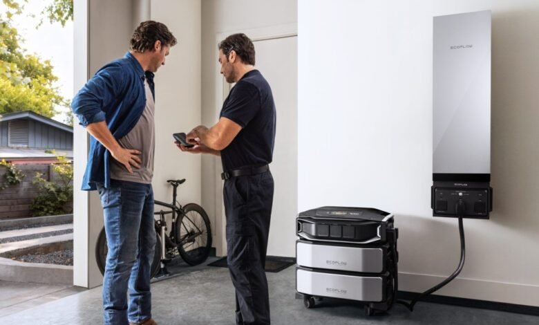 Two men discussing a home battery storage system and its components.