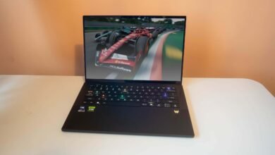 A sleek black laptop displaying a Formula 1 racing game on its screen.