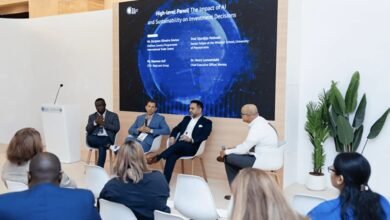 Panelists discuss AI and sustainability on investment decisions at a conference.
