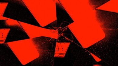 Abstract image of shattered laptop screens in vibrant red and black.