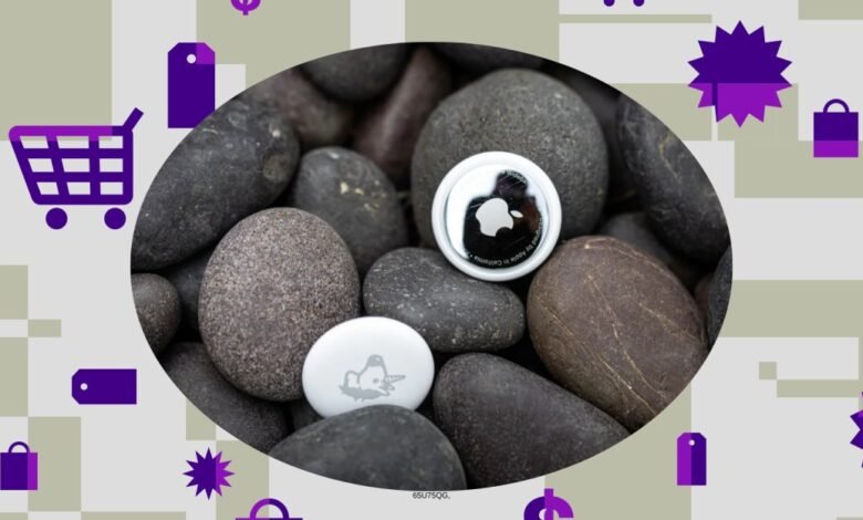 Two Apple AirTags resting on smooth, dark river stones, surrounded by shopping icons.