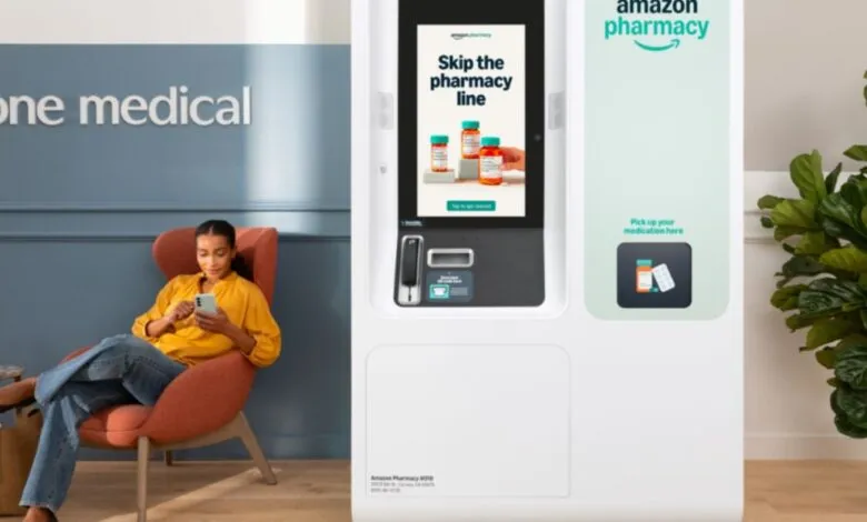 Woman using phone next to Amazon Pharmacy kiosk in a One Medical office.