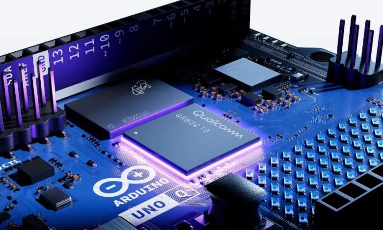 Close-up of an Arduino Uno circuit board with a Qualcomm chip and purple LED lighting.
