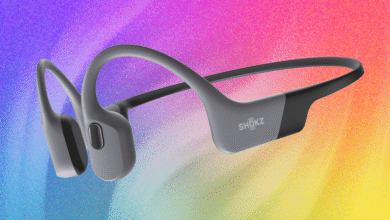 Shokz bone conduction headphones in gray against a vibrant, colorful background.