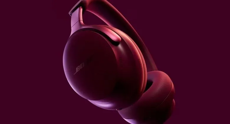 Close-up of Bose QuietComfort Ultra headphones in a deep red color.