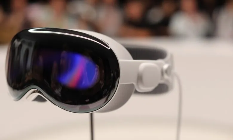 Close-up of a white virtual reality headset with a reflective black visor showing colorful digital display.
