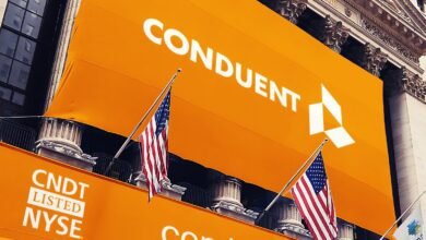 Conduent logo and ticker symbol CNDT listed on NYSE, with American flags flying.
