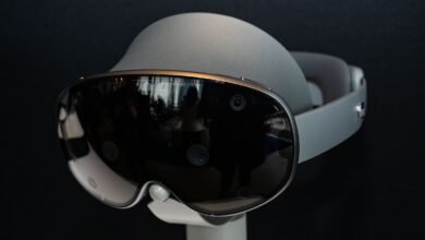 Close-up of a sleek, futuristic virtual reality headset with a dark visor and silver accents.