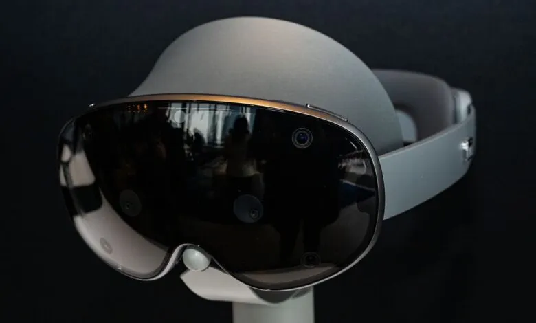 Close-up of a sleek, futuristic virtual reality headset with a dark visor and silver accents.