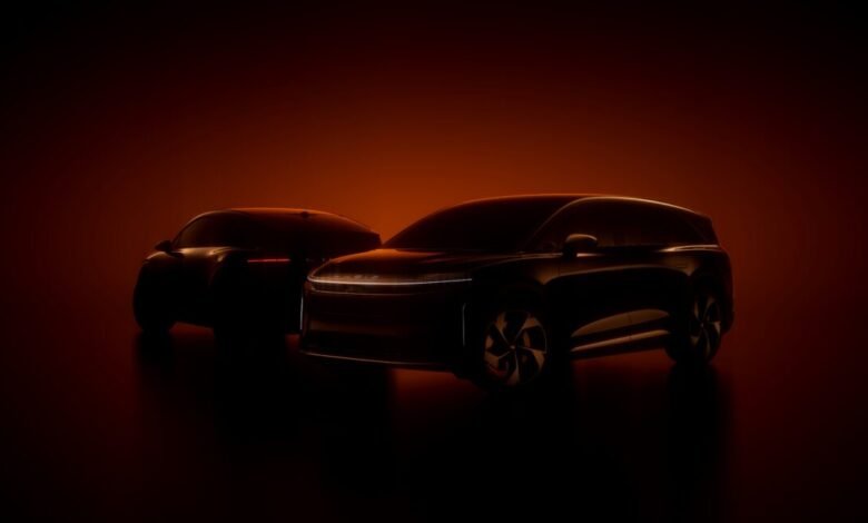 Two dark Lucid electric vehicles silhouetted against a warm orange background.