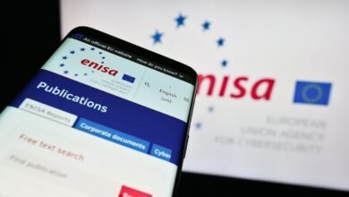 Smartphone displaying the ENISA website with EU stars and logo.