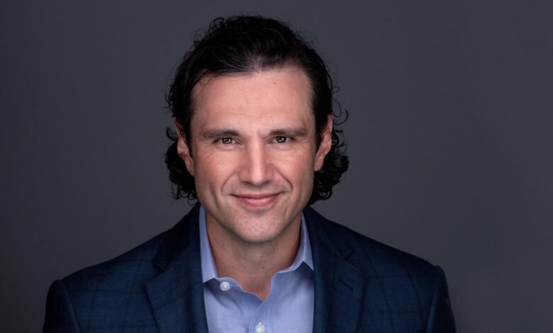 Ely Kahn, Vice President of Product Management at SentinelOne, smiles warmly.