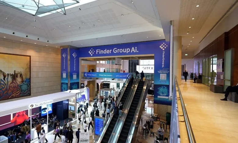 Busy exhibition hall with escalators, booths, and attendees, featuring Finder Group Ai branding.