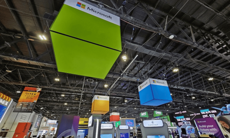 Microsoft branding displayed prominently at a large technology conference with hanging signs and booths.