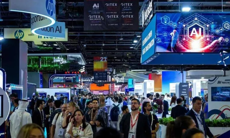 Crowded exhibition hall with people and large digital displays showcasing AI and technology.
