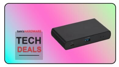 Black USB-C hub with multiple ports on a gradient background.