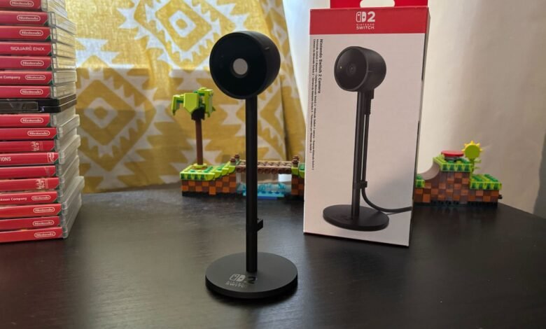 Nintendo Switch 2 Camera accessory on a stand next to its box.