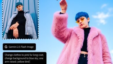 Person with blue hair and yellow sunglasses wearing a pink fur coat against a blue sky.