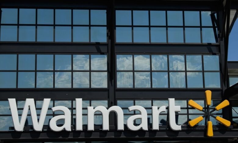 Walmart logo and signage on a modern building exterior with reflective windows.