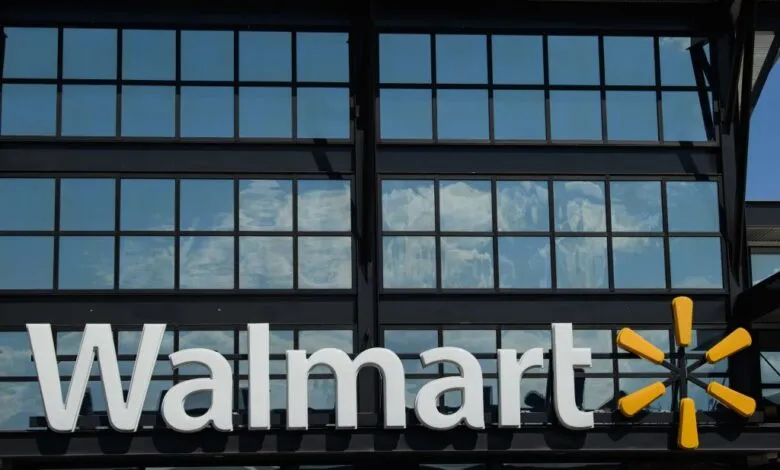 Walmart logo and signage on a modern building exterior with reflective windows.