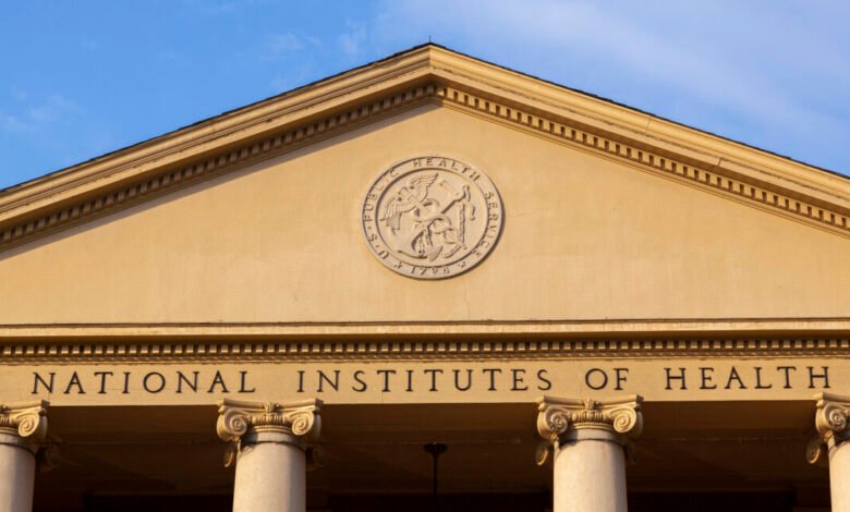Close-up of the National Institutes of Health building facade with columns and seal.