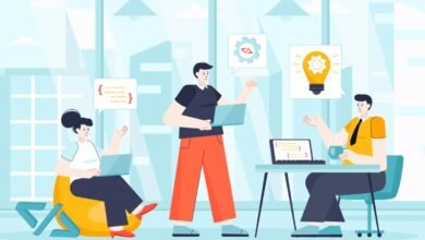 Team of three people collaborating on a project in a modern office setting.