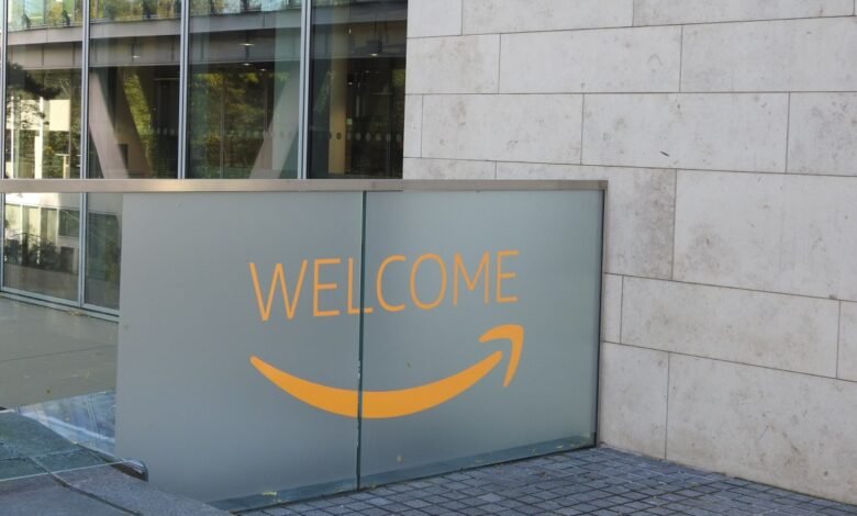Frosted glass panel with orange text 'WELCOME' and Amazon smile logo.
