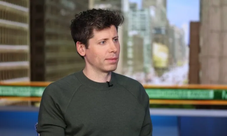 Portrait of Sam Altman, CEO of OpenAI, wearing a dark green sweater.