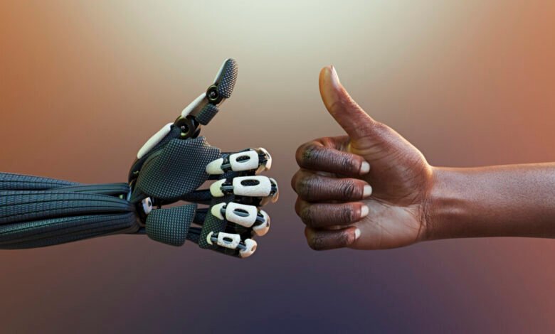 A robotic hand and a human hand giving a thumbs up gesture.