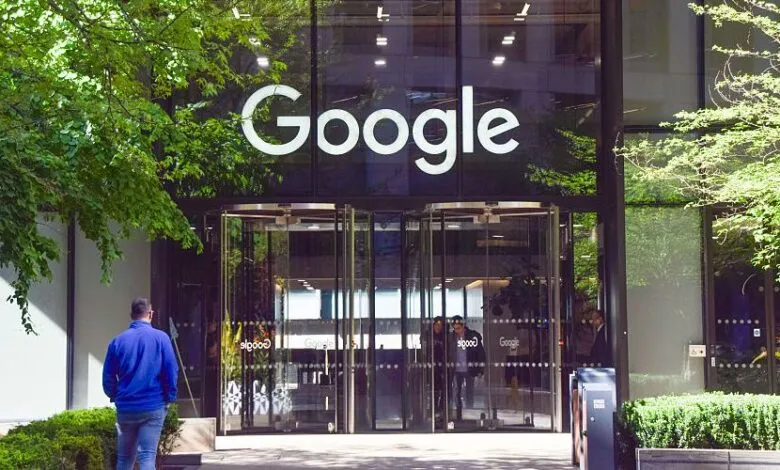 Google headquarters building entrance with revolving doors and trees.
