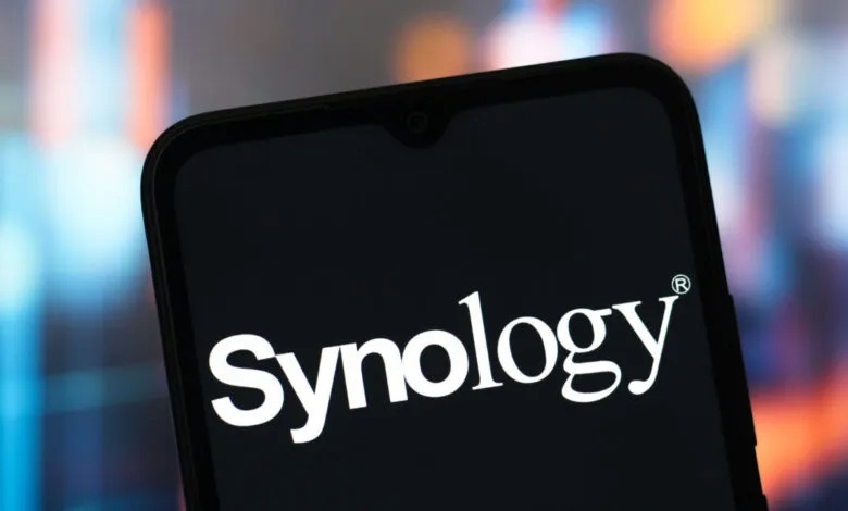 Close-up of a smartphone screen displaying the white Synology logo on a black background.