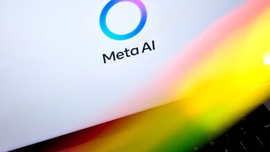 Meta AI logo displayed on a laptop screen with a colorful light reflection.