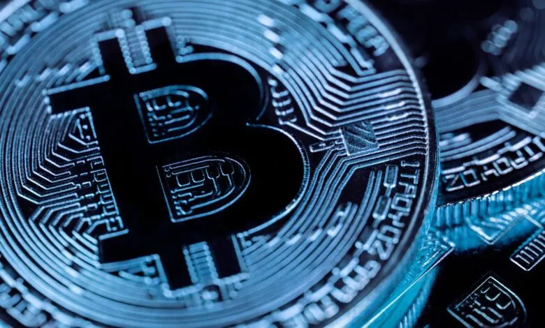Close-up of a shiny Bitcoin cryptocurrency coin with intricate circuit board details.