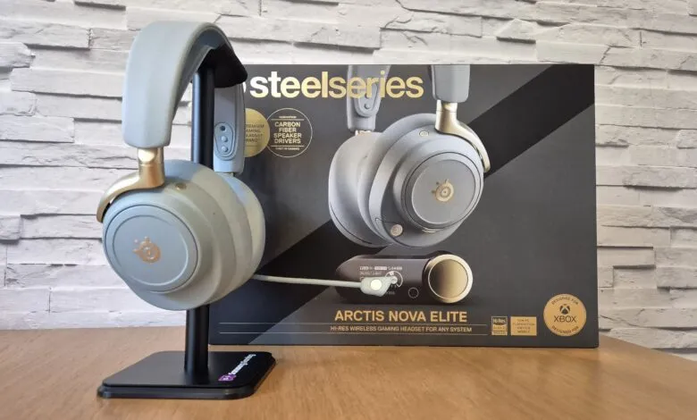 SteelSeries Arctis Nova Elite wireless gaming headset on a stand with its box.