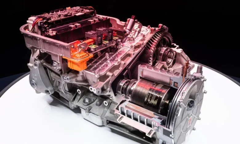 Cutaway view of an electric vehicle powertrain with visible gears and electronics.