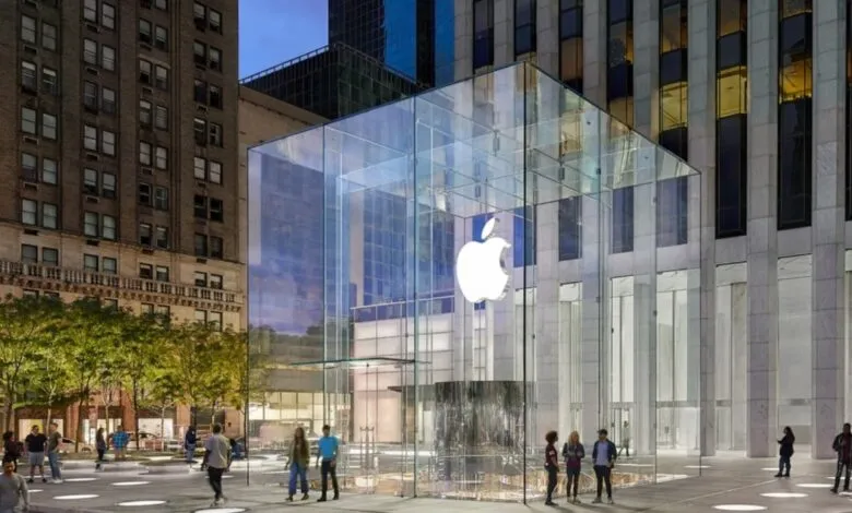 The iconic glass cube Apple Store on Fifth Avenue in New York City at dusk.
