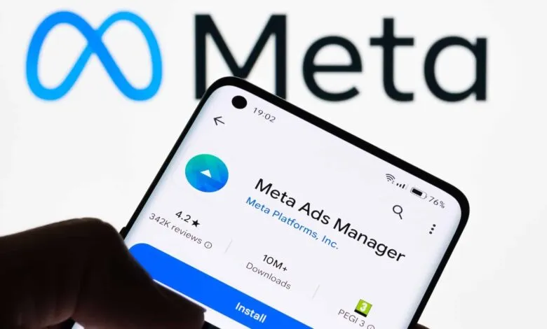 A smartphone displays the Meta Ads Manager app page with the Meta logo in the background.