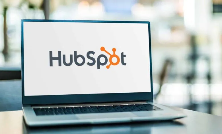 Laptop displaying the HubSpot logo on a white screen.