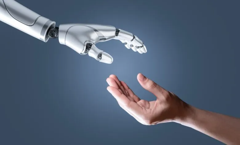 A robotic hand reaching out to a human hand against a dark blue background.