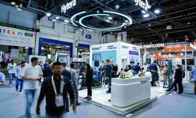 Crowd at a technology exhibition with Hytera and GITEX AI branding visible.