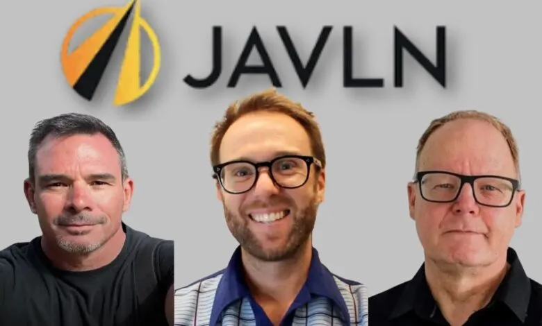 Three men posing for a photo with the JAVLN logo behind them.